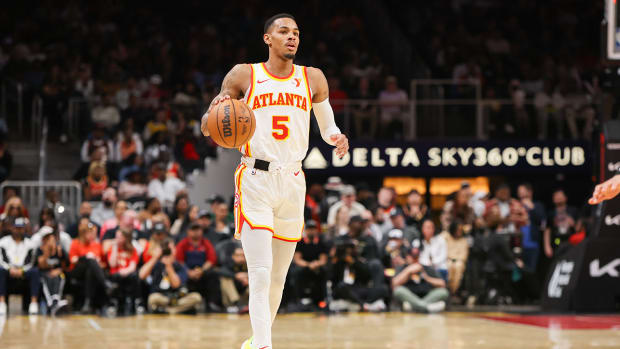 Atlanta Hawks guard Dejounte Murray (5) dribbles against the Utah Jazz in the first quarter at State Farm Arena.